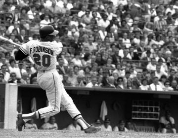 This is a May 19, 1966, file photo showing Baltimore Orioles' Frank Robinson at bat. Hall of Famer Frank Robinson, the first black manager in Major League Baseball and the only player to win the MVP award in both leagues, has died. He was 83. Robinson had been in hospice care at his home in Bel Air. MLB confirmed his death Thursday, Feb. 7, 2019. (AP Photo/File)