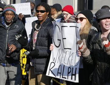 Demonstrators hold signs and chant outside the Governors office at the Capitol in Richmond, Va., Saturday, Feb. 2, 2019. The demonstrators are calling for the resignation of Virginia Governor Ralph Northam after a 30 year old photo of him on his medical school yearbook photo was widely distributed Friday. (Steve Helber/AP Photo)