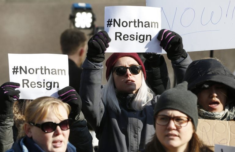 Demonstrators hold signs and chant outside the Governors Mansion at the Capitol in Richmond, Virginia, Saturday, calling for Gov. Ralph Northam to resign. (AP Photo/Steve Helber)