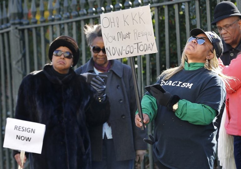 Tara Raigns, of Petersburg, Va., right, reacts to Gov. Ralph Northam's comments during a news conference in the Governor's Mansion in Richmond, Va., on Saturday, Feb. 2, 2019. She joined protesters outside, calling for his resignation. (Alexa Welch Edlund/Richmond Times-Dispatch via AP)