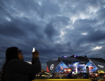 Mercedes-Benz Stadium is lit up ahead of Sunday's NFL Super Bowl 53 football game between the Los Angeles Rams and New England Patriots in Atlanta, Saturday, Feb. 2, 2019. (AP Photo/David Goldman)