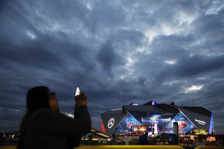 Mercedes-Benz Stadium is lit up ahead of Sunday's NFL Super Bowl 53 football game between the Los Angeles Rams and New England Patriots in Atlanta, Saturday, Feb. 2, 2019. (AP Photo/David Goldman)