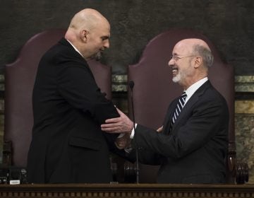 Democratic Gov. Tom Wolf, right, shakes hands with Lt. Gov. John Fetterman before he delivers his budget address for the 2019-20 fiscal year to a joint session of the Pennsylvania House and Senate in Harrisburg, Pa., Tuesday, Feb. 5, 2019. (AP Photo/Matt Rourke)