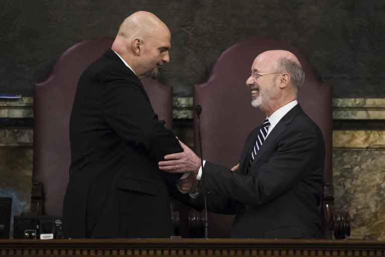 Democratic Gov. Tom Wolf, right, shakes hands with Lt. Gov. John Fetterman before he delivers his budget address for the 2019-20 fiscal year to a joint session of the Pennsylvania House and Senate in Harrisburg, Pa., Tuesday, Feb. 5, 2019. (AP Photo/Matt Rourke)