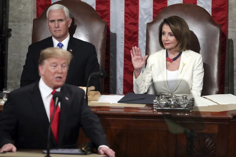 Speaker of the House Nancy Pelosi, D-Calif., raises her hand in a gesture to quiet the Democrats as President Donald Trump delivers his State of the Union address to a joint session of Congress on Capitol Hill in Washington, as Vice President Mike Pence watches, Tuesday, Feb. 5, 2019. (Andrew Harnik/AP Photo)