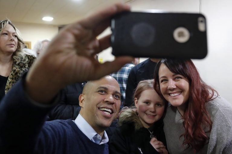 U.S. Sen. Cory Booker, D-N.J., poses for a photo with Alyssa Benson, of Mason City, Iowa, (right), and her daughter Jersey, (center), during a meet and greet with local residents at the First Congregational United Church of Christ, Friday, Feb. 8, 2019, in Mason City, Iowa. (Charlie Neibergall/AP Photo)