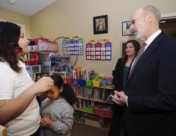 Pennsylvania Gov. Tom Wolf talks with Misericordia University student and mother Rochelle Jade Scott and her daughter Sky as he visited Misericordia University in Dallas, Pa., Friday, Feb. 8, 2019, to tour the Ruth Matthews Bourger Women with Children Program and to outline his bold budget plan to create the strongest workforce in the nation. (Mark Moran/The Citizens' Voice via AP)