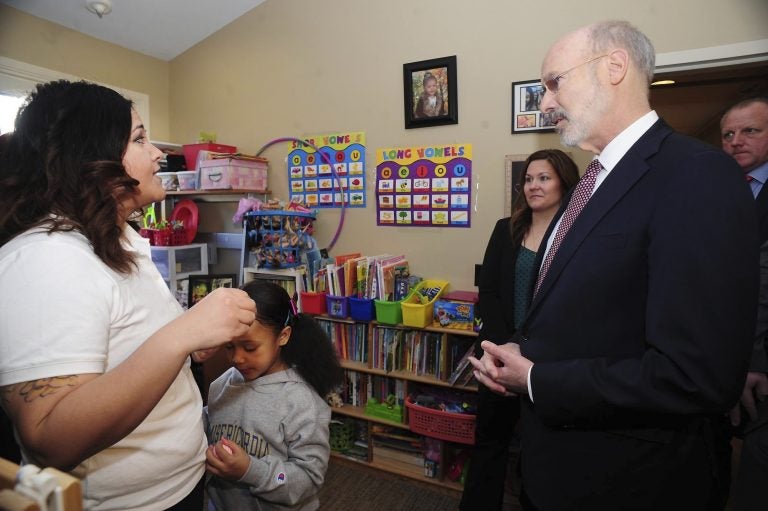 Pennsylvania Gov. Tom Wolf talks with Misericordia University student and mother Rochelle Jade Scott and her daughter Sky as he visited Misericordia University in Dallas, Pa., Friday, Feb. 8, 2019, to tour the Ruth Matthews Bourger Women with Children Program and to outline his bold budget plan to create the strongest workforce in the nation. (Mark Moran/The Citizens' Voice via AP)