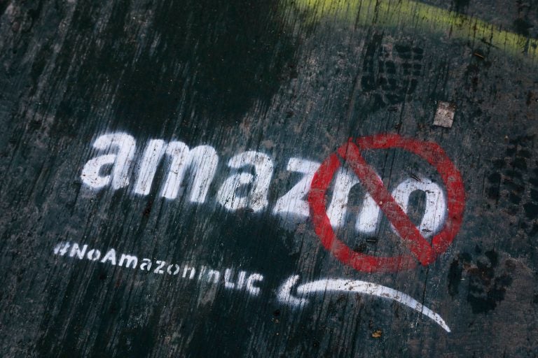 In this Nov. 16, 2018, file photo graffiti has been painted on a sidewalk by someone opposed to the location of an Amazon headquarters in the Long Island City neighborhood in the Queens borough of New York. Local opposition to the proposed Amazon campus grew quickly with grievances that the deal was done secretively; Amazon didn’t need nearly $3 billion in tax incentives; and rising rents could push people out of the neighborhood. (Mark Lennihan/AP Photo, File)