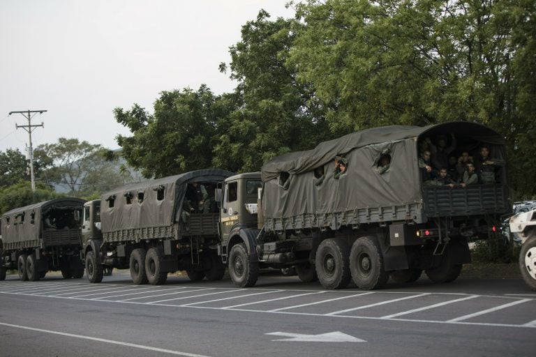 Trucks loaded with officers of the Bolivarian National Guard arrive at the entrance of the Tienditas International bridge that connects Venezuela with Colombia, in Urena, Venezuela, Feb. 21, 2019. (Rodrigo Abd/AP Photo)