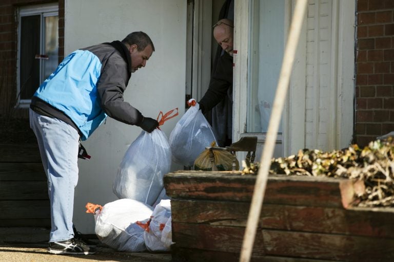 Investigators remove bags from a crime scene at the Robert Morris Apartments in Morrisville, Pa., Tuesday, Feb. 26, 2019. A Pennsylvania woman charged along with her teenage daughter in the deaths of multiple relatives, including children, was arraigned Tuesday on murder charges. The bodies were found Monday inside an apartment at the complex. (Matt Rourke/AP Photo)