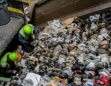 Waste Management technicians clear plastic bags and plastic sheeting from a recycling center screen. Plastic bags and sheeting are a major challenge for recyclers, as they snarl sorting equipment, cause contamination, and drive up processing costs.