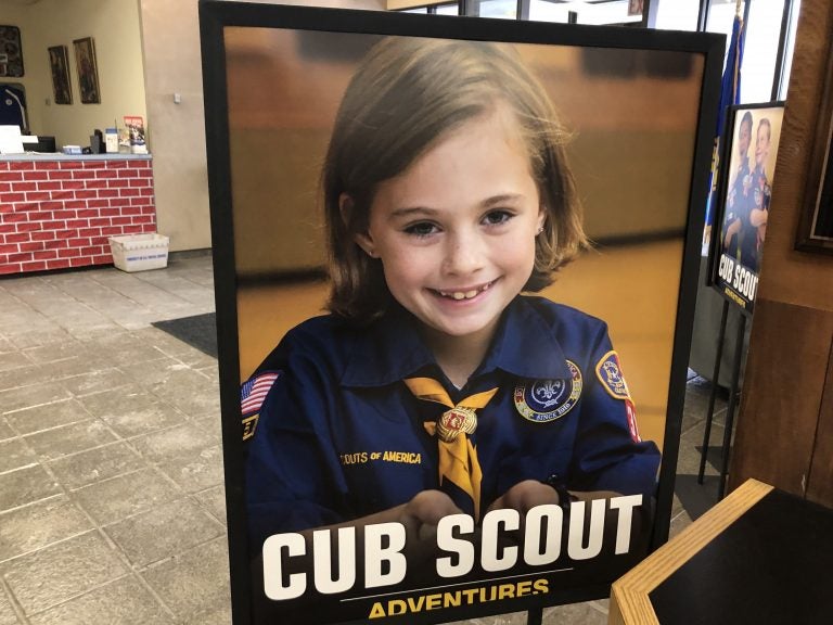 A poster at the entrance of the Laurel Highlands Council headquarters in Pittsburgh shows a young girl in a Cub Scouts uniform. The program for younger kids can include co-ed troops, but older kids will have single-sex troops. (Katie Blackley/WESA)