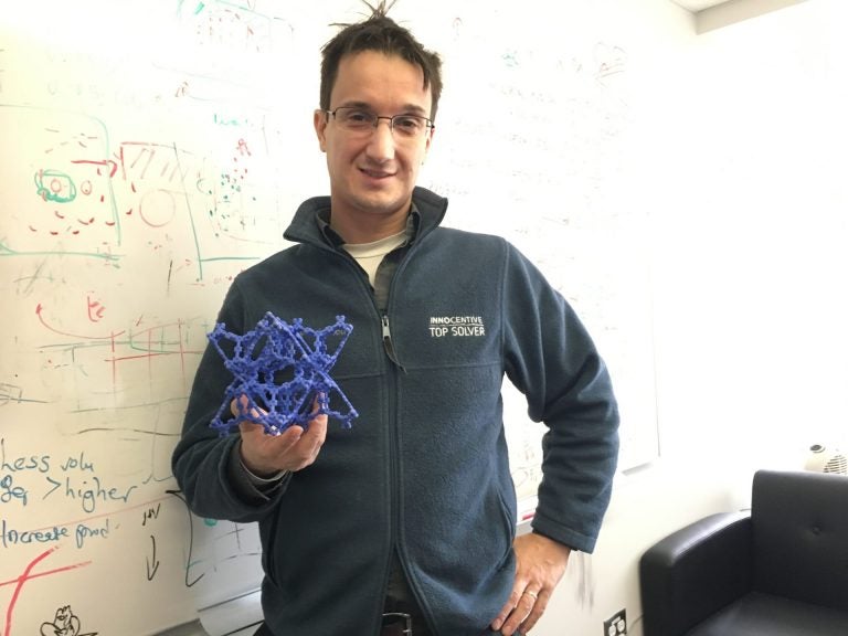 Chris Wilmer, assistant professor of chemical engineering at the University of Pittsburgh, holds a model of a metal organic framework. (Amy Sisk/StateImpact Pennsylvania)