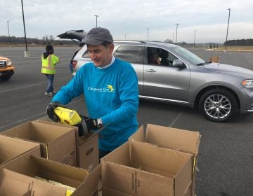 Volunteers load food into cars at the Food Bank of Delaware’s mobile food pantry in Georgetown, Delaware on Friday. (Mark Eichmann/WHYY)