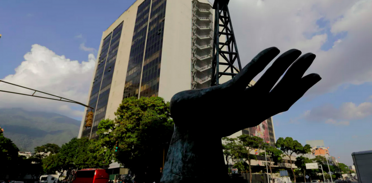 A sculpture of an oil pump held by a human hand stands outside the headquarters of Venezuela’s state-owned oil company. (Fernando Llano/AP Photo)