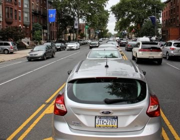 Cars parked in the median on South Broad Street. (Emma Lee/WHYY)