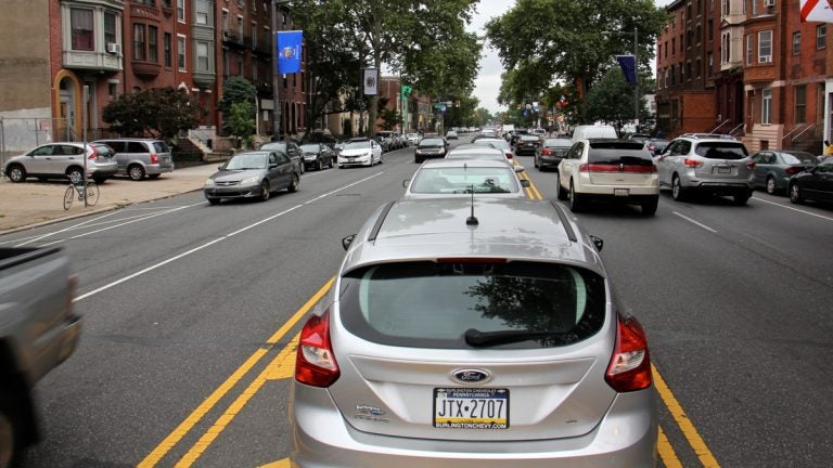 Cars parked in the median on South Broad Street. (Emma Lee/WHYY)