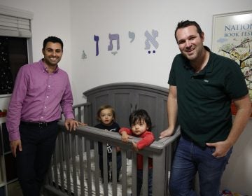 Elad Dvash-Banks (left) and his husband, Andrew, pose for photos with their twin sons, Ethan (center right), and Aiden in their apartment last year in Los Angeles. (Jae C. Hong/AP)