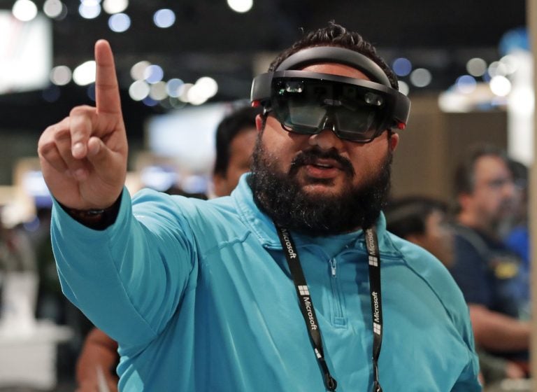 Raman Ghuman demonstrates a HoloLens device at Microsoft's annual conference for software developers on May 7, 2018, in Seattle. Microsoft workers are protesting the use of the augmented reality technology in a U.S. Amy contract. (Elaine Thompson/AP)