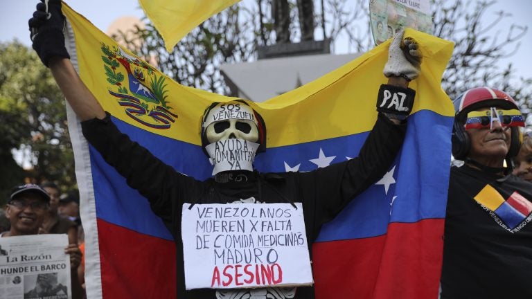 An anti-government protester on Saturday in Caracas wears a sign that reads, 