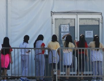 Children line up to enter a tent at the Homestead Temporary Shelter for Unaccompanied Children. Once youth turn 18, they are aged out of the children's shelter and are at risk of being placed in an adult detention facility.
(Wilfredo Lee/AP)