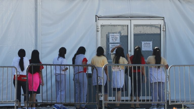 Children line up to enter a tent at the Homestead Temporary Shelter for Unaccompanied Children. Once youth turn 18, they are aged out of the children's shelter and are at risk of being placed in an adult detention facility.
(Wilfredo Lee/AP)