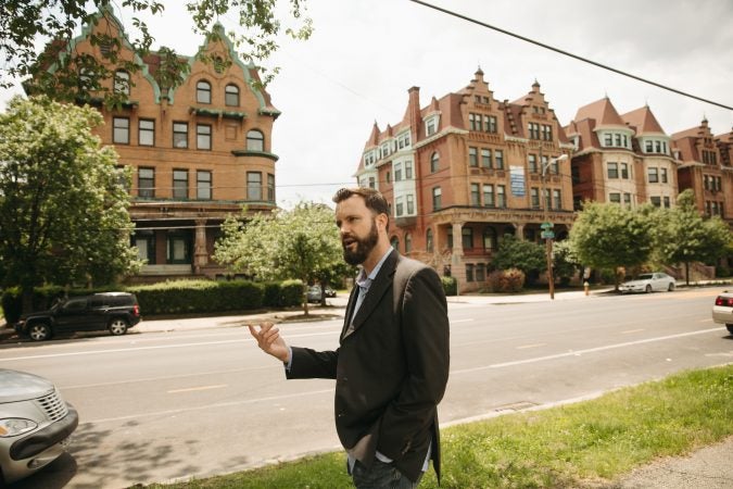 Chris Spahr, director of Centennial Parkside CDC, on Parkside Avenue. (Neal Santos for PlanPhilly)