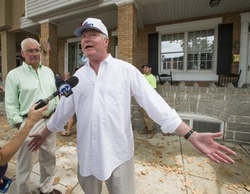John Dougherty, (right), makes some brief comments to the media, in Philadelphia. The powerful union boss who has held a tight grip on construction jobs and politics in the Philadelphia region and beyond has been indicted in an FBI probe along with a city councilman and at least six others. Federal prosecutors say Dougherty used union funds as 