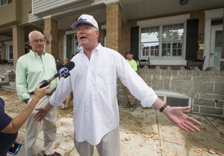 John Dougherty, (right), makes some brief comments to the media, in Philadelphia. The powerful union boss who has held a tight grip on construction jobs and politics in the Philadelphia region and beyond has been indicted in an FBI probe along with a city councilman and at least six others. Federal prosecutors say Dougherty used union funds as 