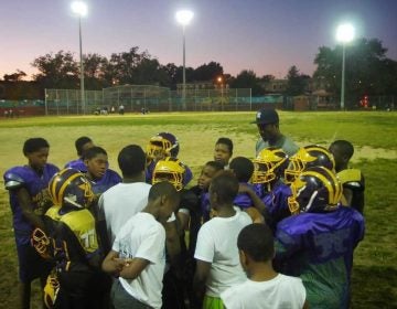 Mo Better Jaguars' coaches and players huddle at the end of practice at Betsy Head Park in Brownsville, Brooklyn in September 2014. (Courtesy of Albert Samaha)