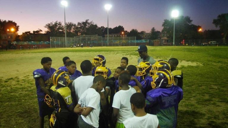 Mo Better Jaguars' coaches and players huddle at the end of practice at Betsy Head Park in Brownsville, Brooklyn in September 2014. (Courtesy of Albert Samaha)