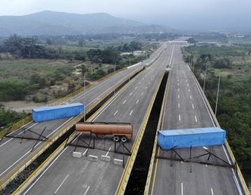 The Tienditas Bridge connecting Colombia and Venezuela has been blocked by Venezuelan military forces, as seen here on Wednesday. Opposition leader Juan Guaidó and U.S. Secretary of State Mike Pompeo are demanding that humanitarian aid be allowed to enter. (Edinson Estupinan/AFP/Getty Images)