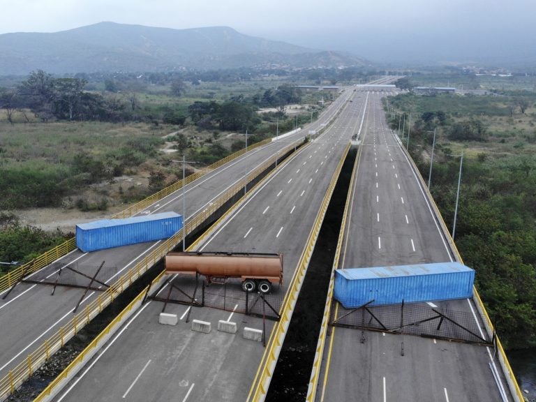 The Tienditas Bridge connecting Colombia and Venezuela has been blocked by Venezuelan military forces, as seen here on Wednesday. Opposition leader Juan Guaidó and U.S. Secretary of State Mike Pompeo are demanding that humanitarian aid be allowed to enter. (Edinson Estupinan/AFP/Getty Images)