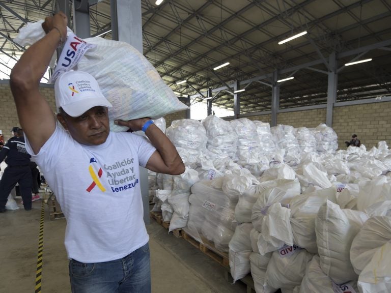 A volunteer carries a bag with U.S. humanitarian aid goods in Cúcuta, Colombia, along the border with Venezuela, on Feb. 8. (Raul Arboleda/AFP/Getty Images)