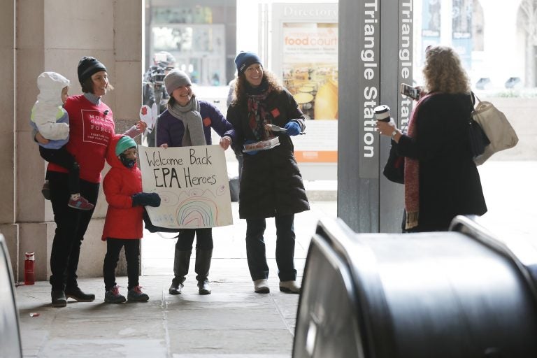 Environmental activists Liz Brandt (from left), with her daughters, Natalia, 3, and Valencia Bednar, 5; Martha Roberts; and Molly Rauch pose for a photograph while welcoming Environmental Protection Agency employees back to work on Jan. 28 in Washington, D.C. Furloughed employees returned to work following the end of the longest-ever partial federal government shutdown. (Chip Somodevilla/Getty Images)