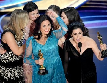 Producer Melissa Berton (center) and director Rayka Zehtabchi (right) accept an Oscar for their documentary 'Period. End of Sentence.' (Kevin Winter/Getty Images)