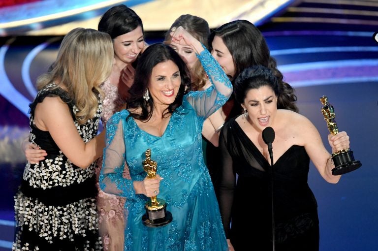 Producer Melissa Berton (center) and director Rayka Zehtabchi (right) accept an Oscar for their documentary 'Period. End of Sentence.' (Kevin Winter/Getty Images)