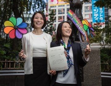 In this 2015 photo, Koyuki Higashi (left) and Hiroko Masuhara celebrate and hold up their same-sex marriage certificate in Tokyo. Today 13 gay couples filed a lawsuit arguing the country's general rejection of same-sex marriage rights violates the constitution. (Christopher Jue/Getty Images)