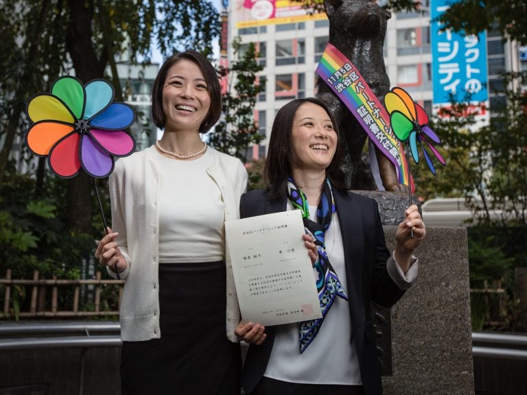 In this 2015 photo, Koyuki Higashi (left) and Hiroko Masuhara celebrate and hold up their same-sex marriage certificate in Tokyo. Today 13 gay couples filed a lawsuit arguing the country's general rejection of same-sex marriage rights violates the constitution. (Christopher Jue/Getty Images)