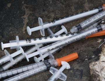 Discarded syringes lay near near train tracks in Philadelphia, Monday, July 31, 2017