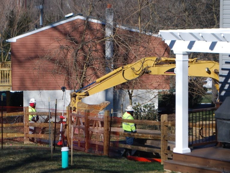 Crews worked on Monday Jan. 21 to stabilize a new sinkhole that opened up at Lisa Drive, a suburban development in West Whiteland Township, Chester County where Sunoco operates its Mariner East pipelines. (Jon Hurdle/StateImpact Pennsylvania)