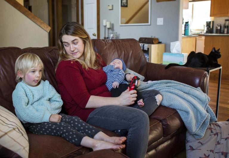 Amber Gorrow and her daughter, Eleanor, 3, pick out a show to watch after Eleanor's nap at their home in Vancouver, Wash., on Wednesday. Eleanor has gotten her first measles vaccine, but Gorrow's son, Leon, 8 weeks, is still too young to be immunized. (Alisha Jucevic/Getty Images)