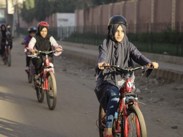 Zulekha Dawood leads the group of female cyclists through the impoverished Lyari neighborhood in Karachi, Pakistan's capital. They ride early in the morning to avoid the worst of the traffic. (Diaa Hadid/NPR)