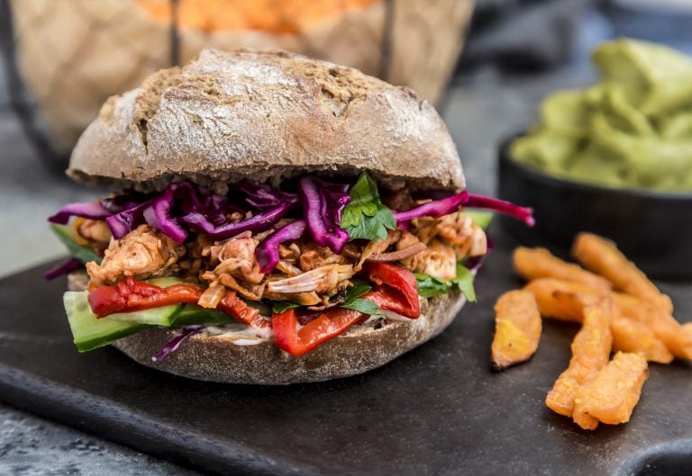 Focusing less on the meat-free or health aspects of plant-based dishes, like this jackfruit burger — and more on their flavor, mouthfeel and provenance — could go a long way toward getting meat lovers to choose these options more often. That's according to research by the World Resources Institute's Better Buying Lab in conjunction with food chains, marketers and behavioral economists.
(Westend61/Getty Images)