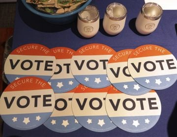 Computer mouse pads with Secure the Vote logo on them are seen on a vendor's table at a convention of state secretaries of state Saturday, July 14, 2018, in Philadelphia. (Mel Evans/AP Photo)