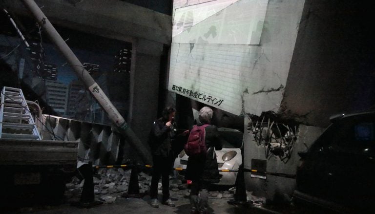 Reporter Susan Phillips (left) and Mary Saso check the details of their mock disaster on a tablet computer at the start of the training at Tokyo Bayshore Disaster Prevention Park.