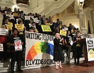 In this file photo, Pat Albright speaks at the state Capitol in defense of the General Assistance program, flanked by sign language translators. (Katie Meyer/WITF)