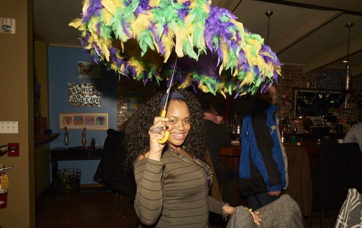 Alicia Williams, 34, a self-proclaimed Mardi Gras Enthusiast, celebrates Fat Tuesday at Acadia Bar in South Philadelphia. (Natalie Piserchio for WHYY)