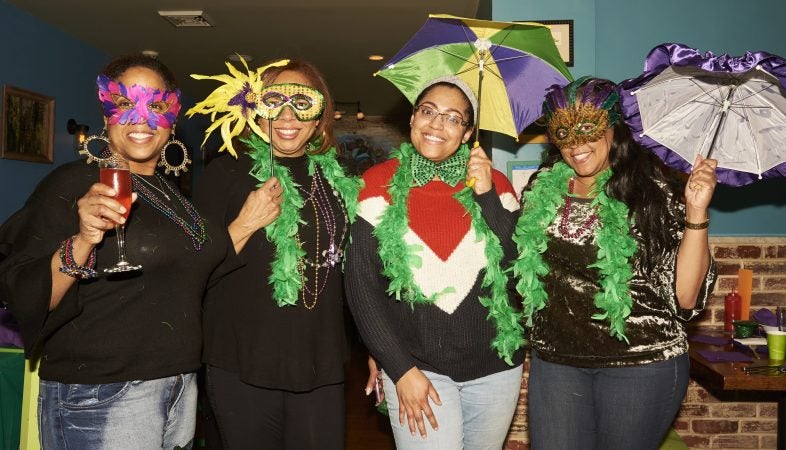 Marki Levere, Tarlynn Levere, Anessa Cross, and Deenee Levere celebrate Fat Tuesday at the Acadia Bar in South Philadelphia. (Natalie Piserchio for WHYY)